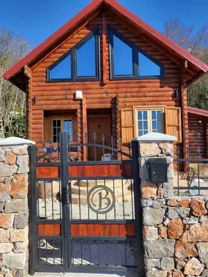 a log cabin with a gate in front of it at Villa Skyline in Kotor