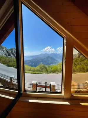 a window with a view of a mountain view at Villa Skyline in Kotor