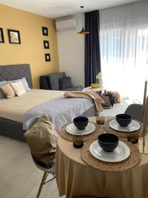 a bedroom with a bed and two tables with bowls on it at Apartments Vuksanovic in Bar