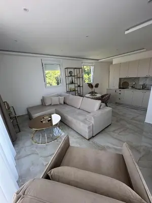 a living room with a couch and a table at Apartments Vuksanovic in Bar