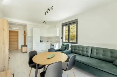 a living room with a green couch and a table at Apartment Ava in Kotor