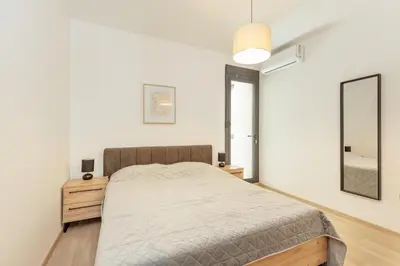 a bedroom with a bed and a mirror at Apartment Ava in Kotor