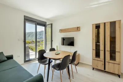 a living room with a table and chairs and a couch at Apartment Ava in Kotor