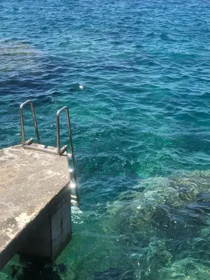 a view of the clear blue water near a pier at CONTiNUUM in Ulcinj