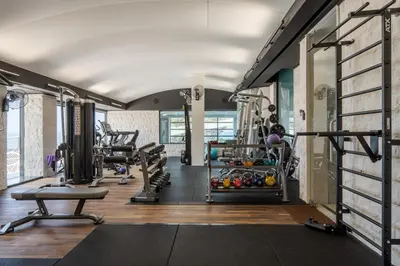 a gym with treadmills and machines in a room at CONTiNUUM in Ulcinj
