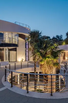 a palm tree in front of a building at CONTiNUUM in Ulcinj