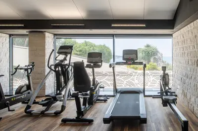 a gym with tread machines and a large window at CONTiNUUM in Ulcinj