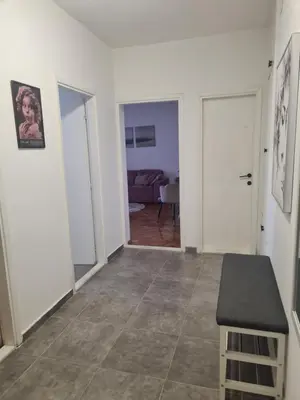 a living room with a table and a couch at Serenity City Centre in Podgorica