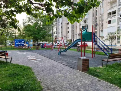 a park with a playground with a slide and benches at Serenity City Centre in Podgorica
