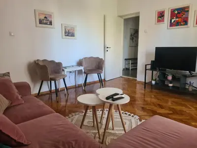 a living room with a couch and a tv at Serenity City Centre in Podgorica