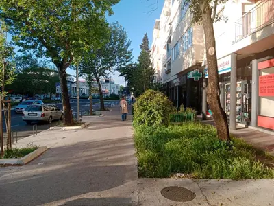 a person walking down a street in a city at Serenity City Centre in Podgorica