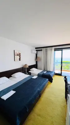 a hotel room with two beds and a large window at CORPUS A - Hotel Albatros in Ulcinj