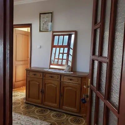 a room with a vanity with a mirror and a door at City Center Two-Bedroom Apartment in Ulcinj