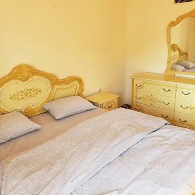 a bedroom with two beds and a dresser at City Center Two-Bedroom Apartment in Ulcinj