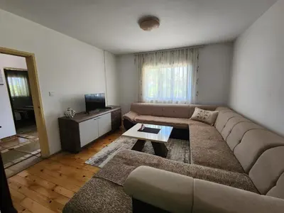 a living room with a couch and a table at Gazdinstvo Đurović in Dobra Voda