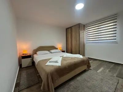 a bedroom with a bed with two towels on it at Gazdinstvo Đurović in Dobra Voda