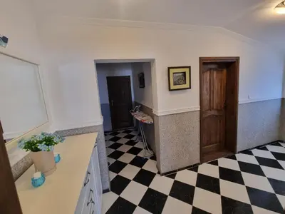 a kitchen with a black and white checkered floor at Apartmani MINA in Bar