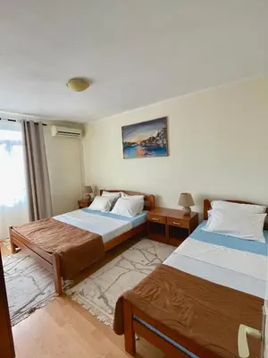a bedroom with two beds and a window at Apartman 200 in Ulcinj