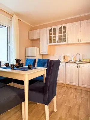 a kitchen with a table and chairs in a room at Apartman 200 in Ulcinj