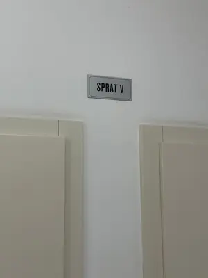a sign that says streaky is hanging above two doors at Laura apartment City kvart in Podgorica