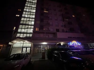 a building with cars parked in front of it at night at Laura apartment City kvart in Podgorica