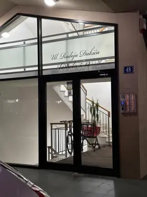 a store front with a sign that reads all victory publishing at Laura apartment City kvart in Podgorica