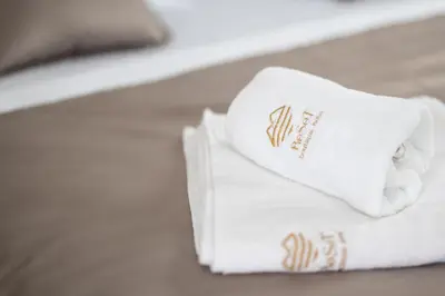 a pair of towels sitting on a bed at Hotel Reset in Budva