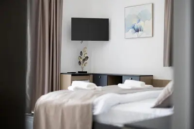 a hotel room with two beds and a television at Hotel Reset in Budva