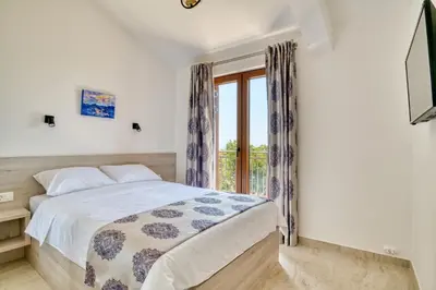 a bedroom with a bed and a window at Seaview Villa Lavanda with pool in Budva