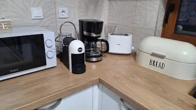 a counter with a coffee maker and a microwave at Seaview Villa Lavanda with pool in Budva