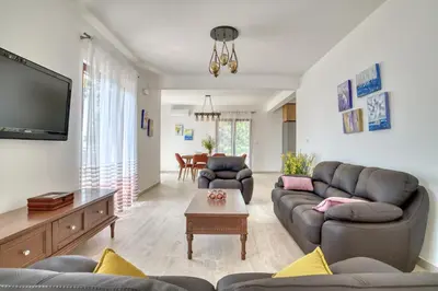 a living room with two couches and a tv at Seaview Villa Lavanda with pool in Budva