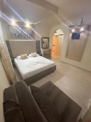 a bedroom with a bed and a couch at Guesthouse Liamra in Ulcinj