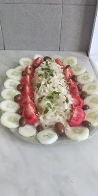 a plate of food with bananas and tomatoes and beans at Apartments Nikola in Bar