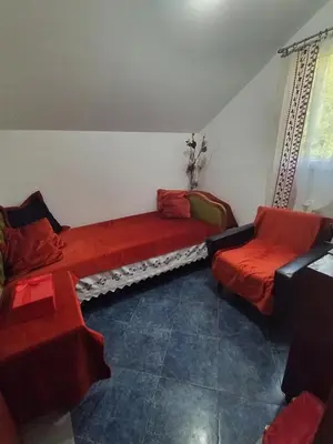 a living room with two beds and two chairs at Apartments Nikola in Bar