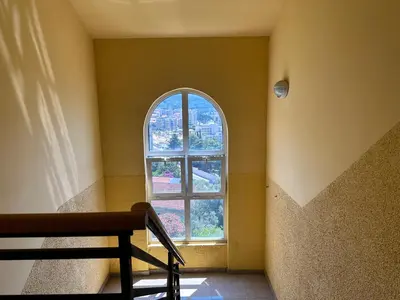 an empty room with a window and a bench at Wonder Apartments in Budva