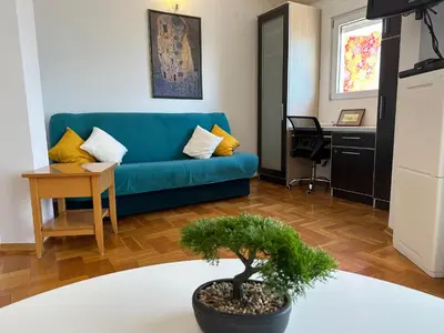 a living room with a blue couch and a table at Wonder Apartments in Budva