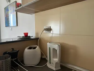 a kitchen with a white appliance on the wall at Wonder Apartments in Budva