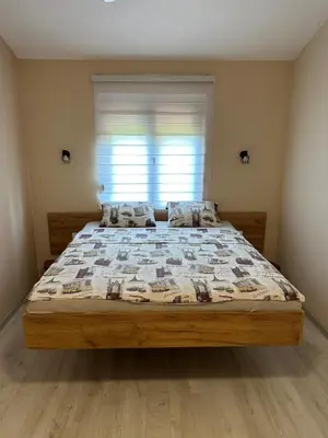a large bed in a bedroom with a window at Green House in Virpazar