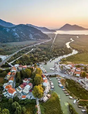 an aerial view of a river with houses and boats at Green House in Virpazar