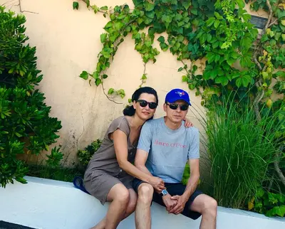 a man and a woman sitting on a bench at Apartments Royal in Budva