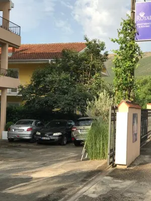 a group of cars parked in a parking lot at Apartments Royal in Budva