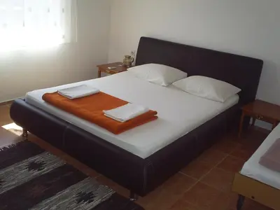 a bed with two towels on it in a room at Apartmani Dado in Ulcinj