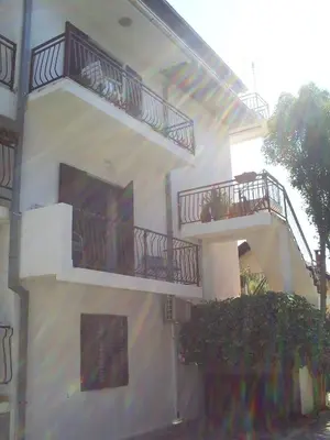 a building with two balconies on the side of it at Apartmani Dado in Ulcinj