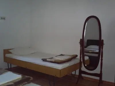 a bedroom with a bed and a mirror at Apartmani Dado in Ulcinj