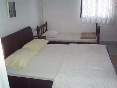 a bedroom with two beds in a room at Apartmani Dado in Ulcinj