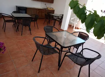 a group of tables and chairs in a room at Apartmani Dado in Ulcinj