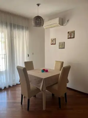 a dining room with a table and chairs and a table and chairsktop at Cozy Montenegro Experience, 50m from the beach in Petrovac na Moru