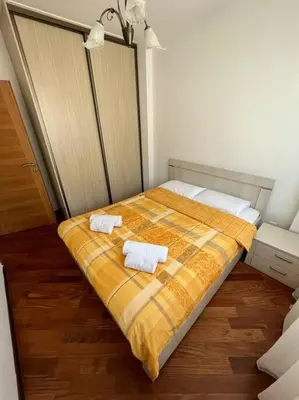 a bedroom with a bed with two towels on it at Cozy Montenegro Experience, 50m from the beach in Petrovac na Moru