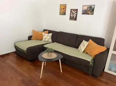 a living room with a couch and a table at Cozy Montenegro Experience, 50m from the beach in Petrovac na Moru