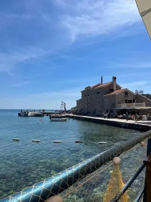 a view of a body of water next to a building at Cozy Montenegro Experience, 50m from the beach in Petrovac na Moru